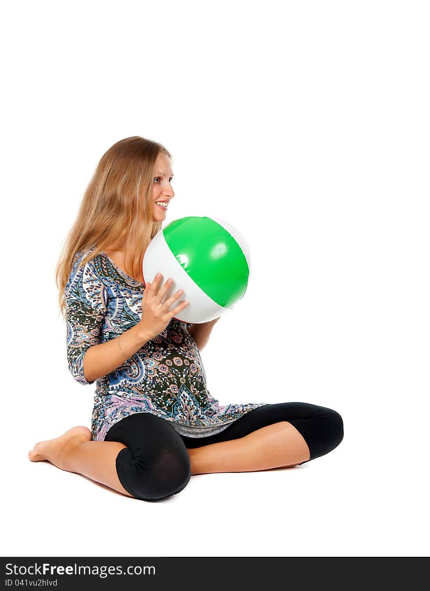 Pregnant girl in an inflatable ball color in the studio on a white background