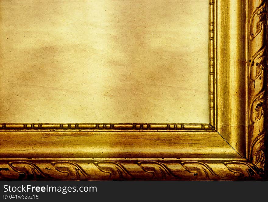 Old antique golden frame on grunge wall