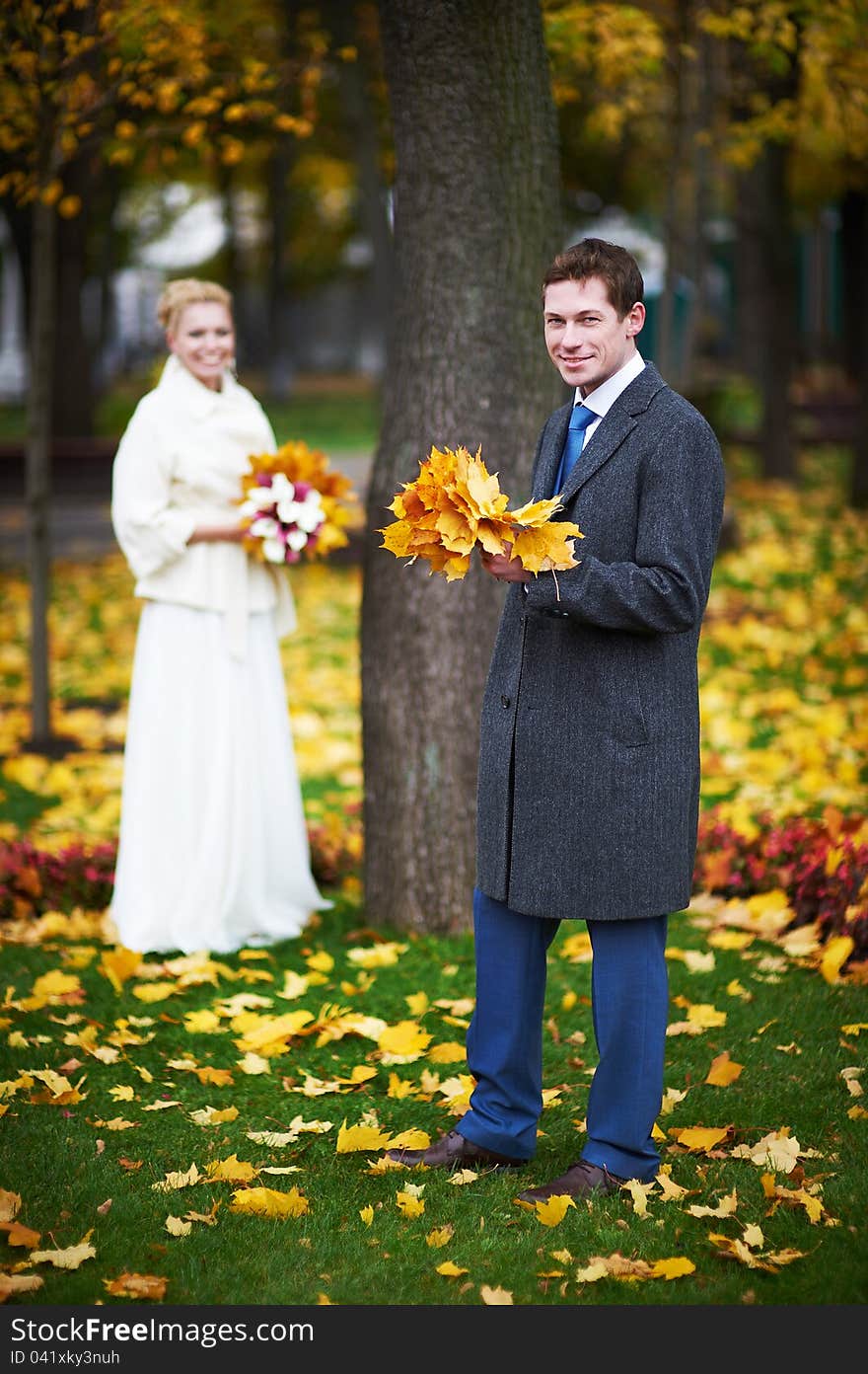 Bride and groom with a maple leaf on a wedding walk