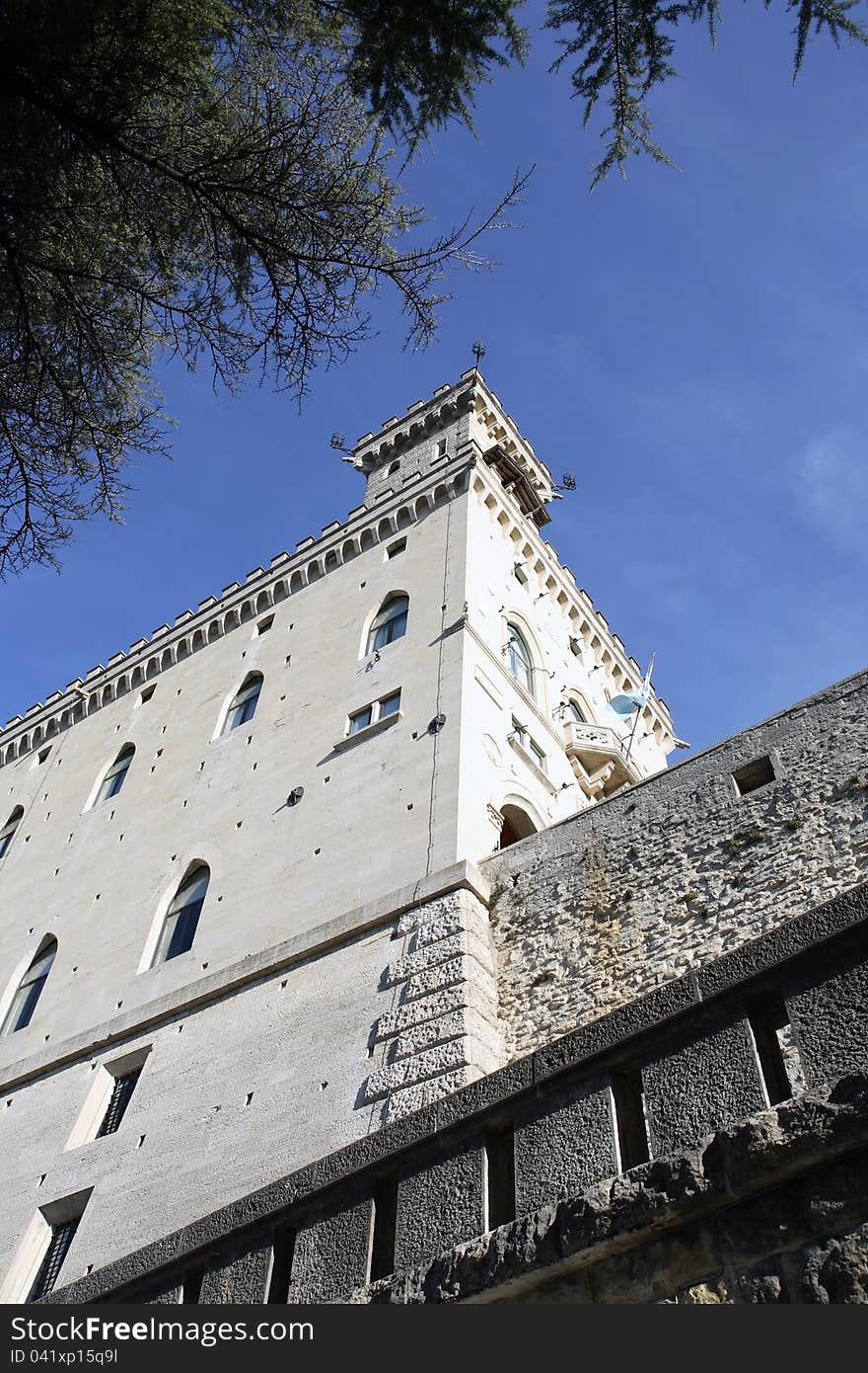 Closeup of ancient fortress wall and tower against blue sky. Closeup of ancient fortress wall and tower against blue sky