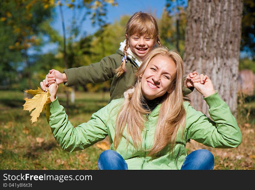 Young Mother And Her Toddler Girl In Autumn