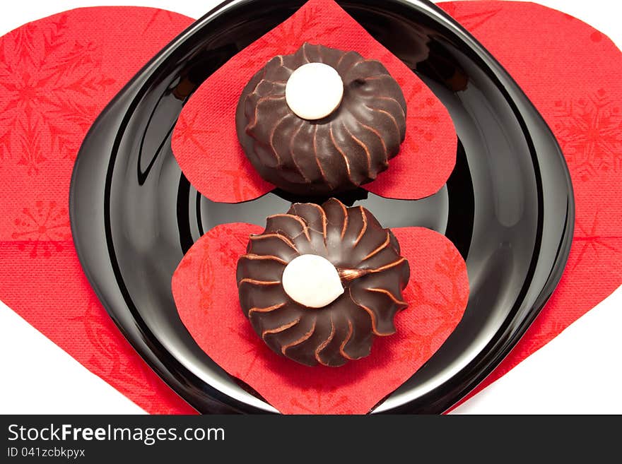 The chocolate cakes on the plate with heart-shaped napkins