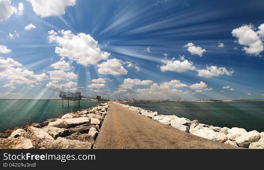 Road on the sea with cloudy sky