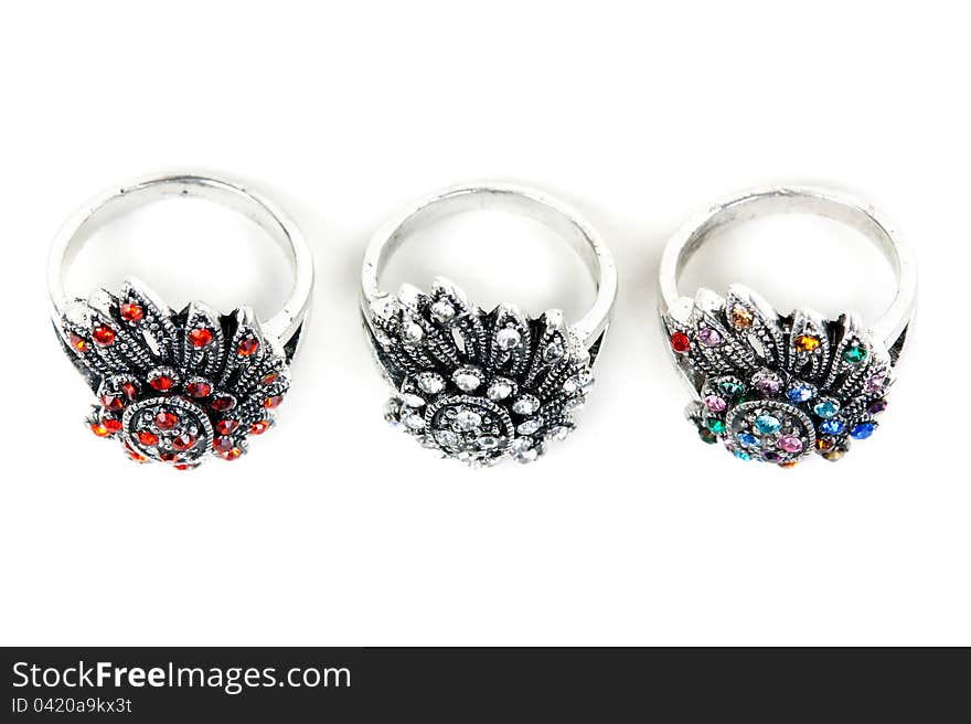 Three silver rings with precious stones