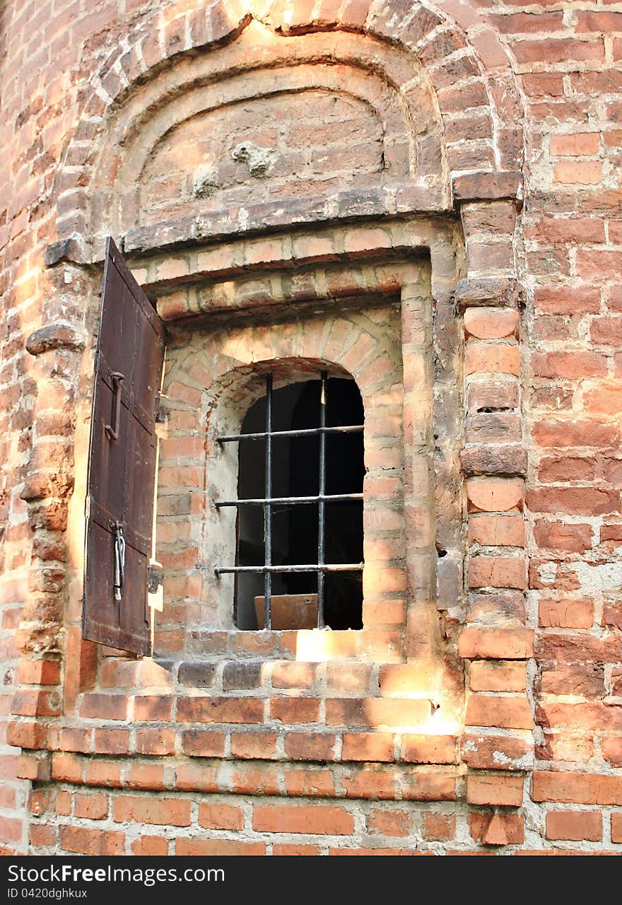 Window with bar in the wall of the medieval building. Window with bar in the wall of the medieval building