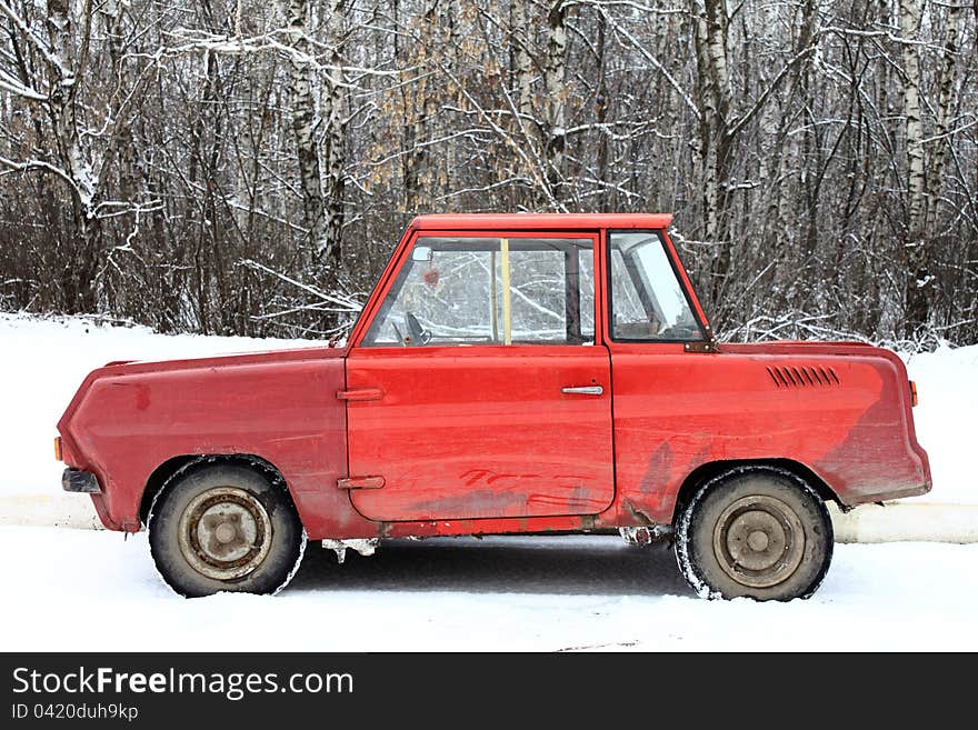 Old red car in the snow