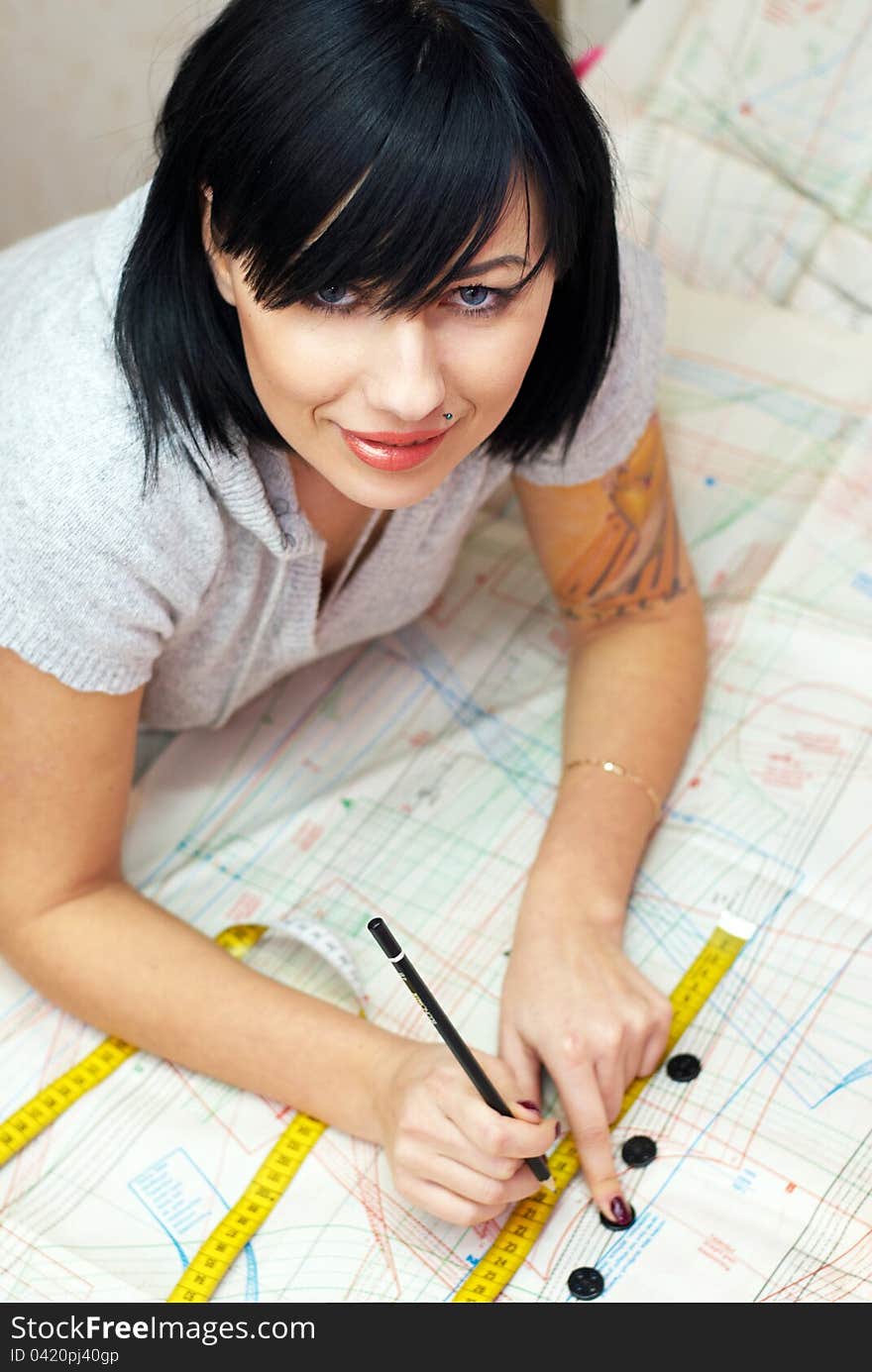 Young seamstress measuring distance