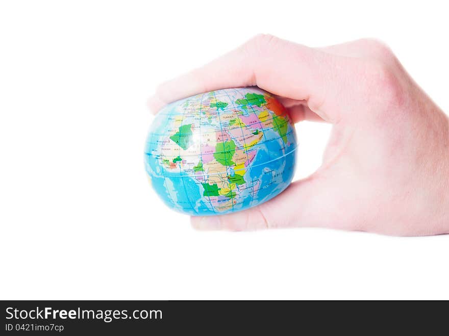 Man's hand compresses the a globe on a white background. Man's hand compresses the a globe on a white background