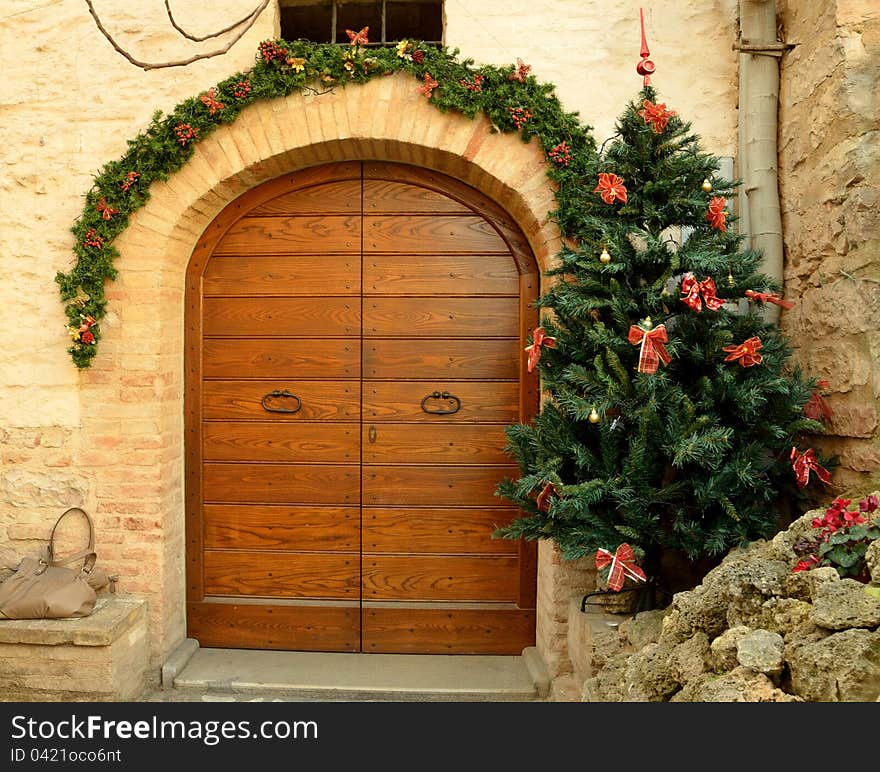 Wooden door in Spello with a christmas tree