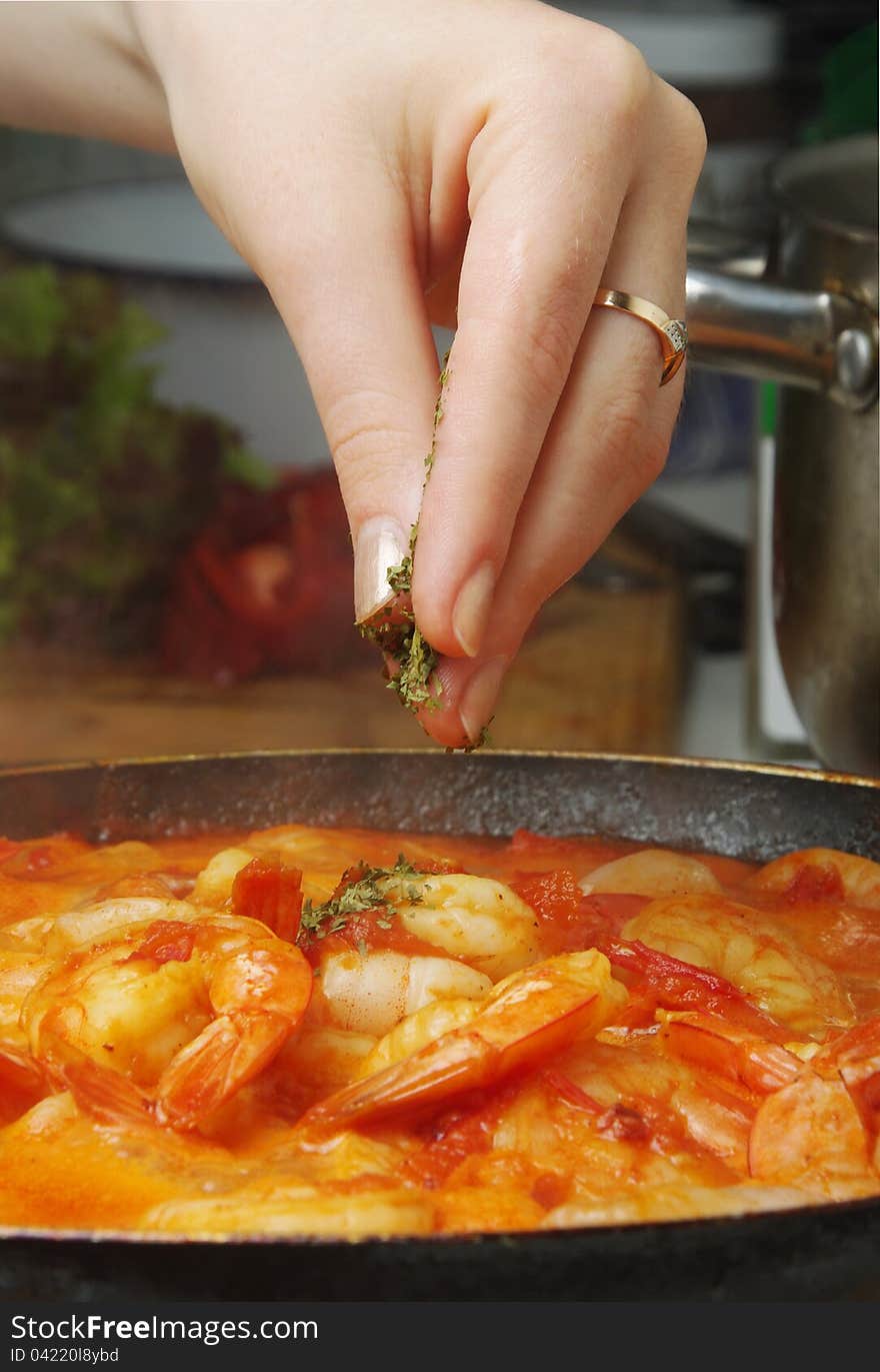 Adding herbs to delicious prawns. Adding herbs to delicious prawns