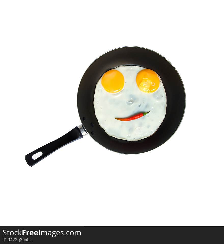 Smiley egg with red chilli on a pan. Smiley egg with red chilli on a pan