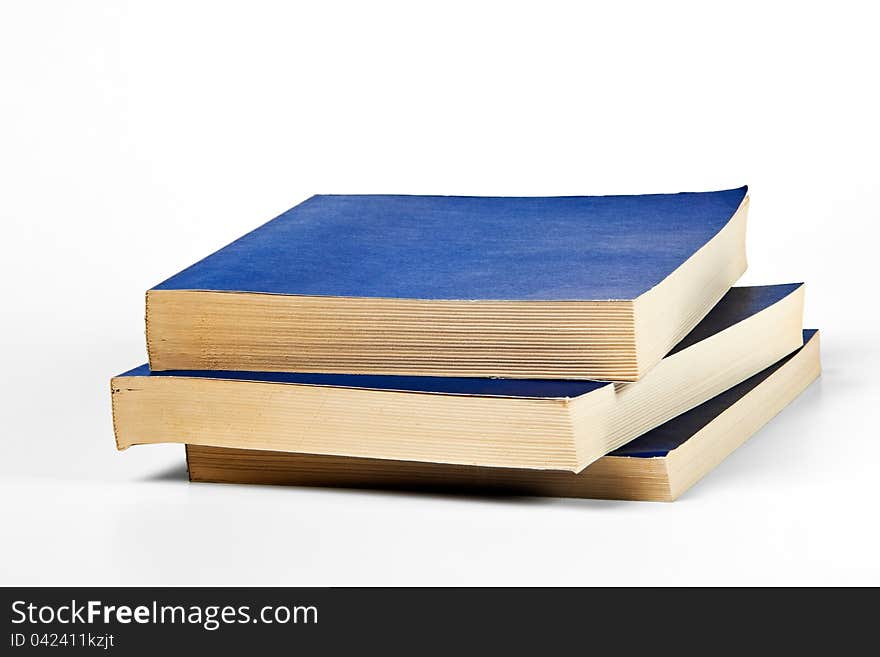 Three blank blue books on white