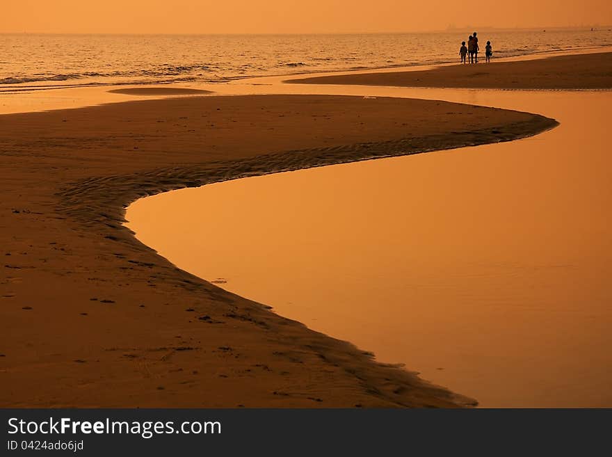 The walking children on a warm beach at twilight. The walking children on a warm beach at twilight