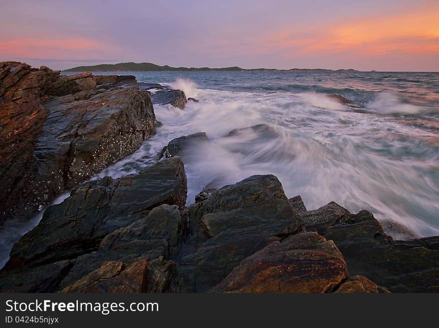 The splashing wave in the evening at Rayong beach. The splashing wave in the evening at Rayong beach