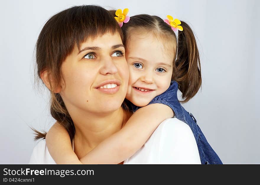 Little cute girl hugging her mother