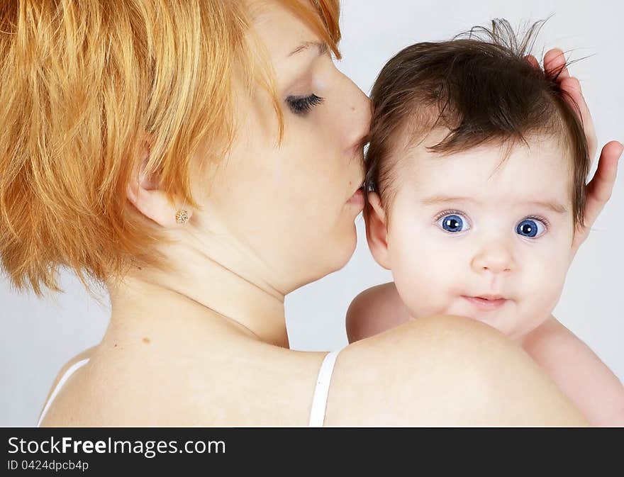 Portrait of a beautiful happy mother and the little cute baby. Portrait of a beautiful happy mother and the little cute baby