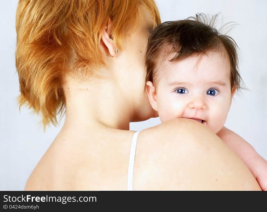 Portrait of a beautiful happy mother and the little cute baby. Portrait of a beautiful happy mother and the little cute baby