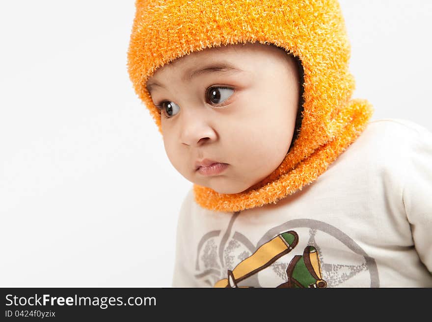 Indian curious  boy baby in cap looking at the camera on white background.