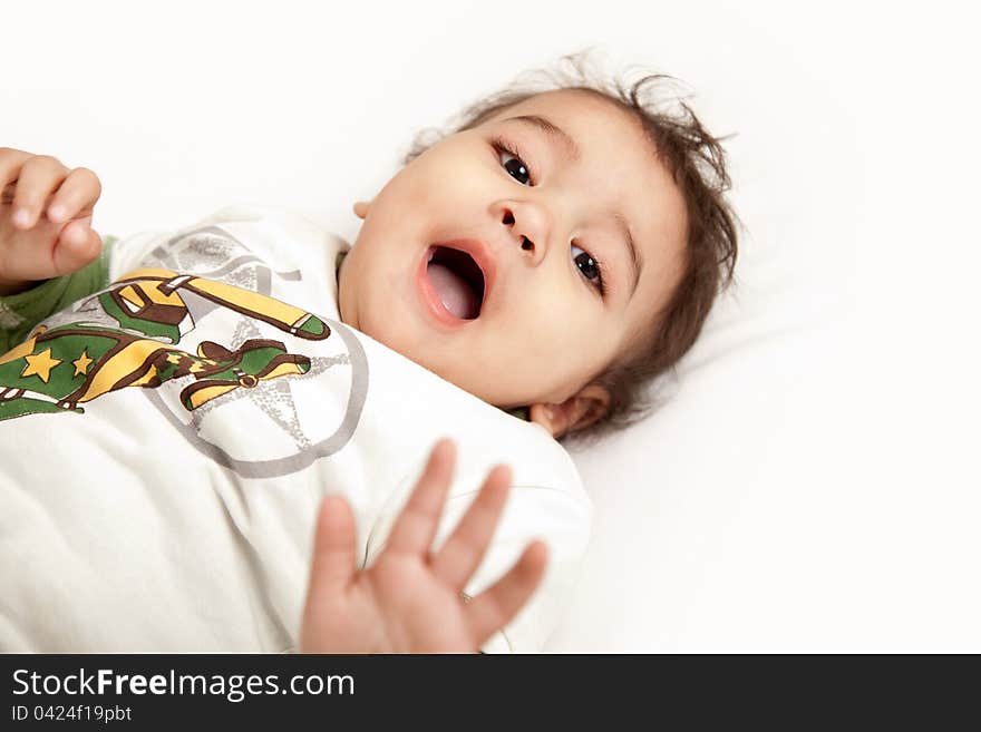 Adorable Indian baby laughing a over white background