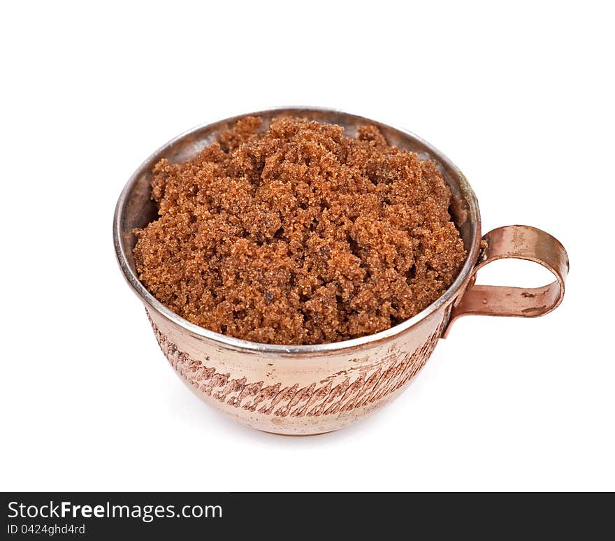 Brown sugar in a cup isolated white background