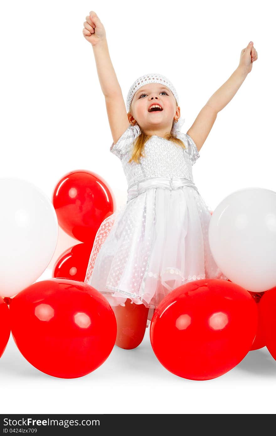 Happy little girl with hands up next to balloons, laughing and waving