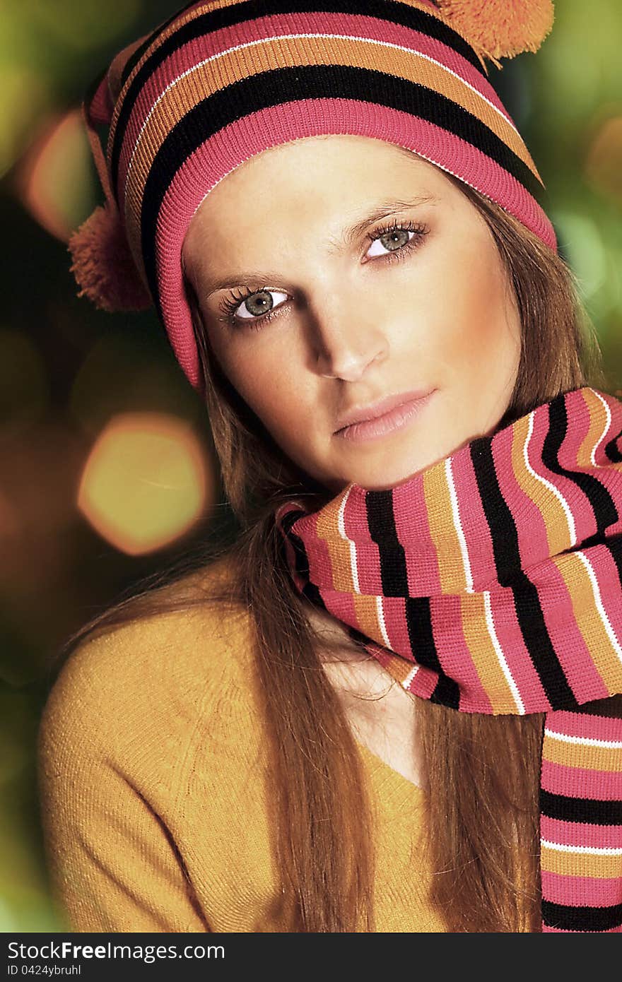 Beautiful young woman wearing worm colored hat and scarf. Beautiful young woman wearing worm colored hat and scarf