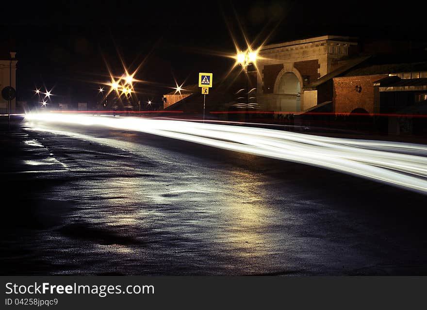 Car trailing white lights at night on the street. Car trailing white lights at night on the street