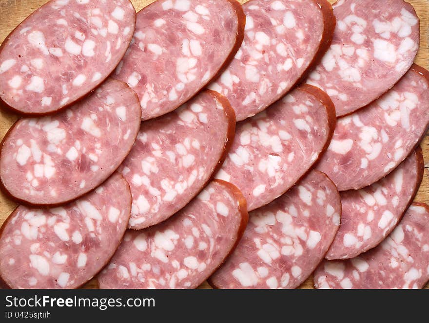 Background made from lot of sliced salami. Extreme closeup. Background made from lot of sliced salami. Extreme closeup