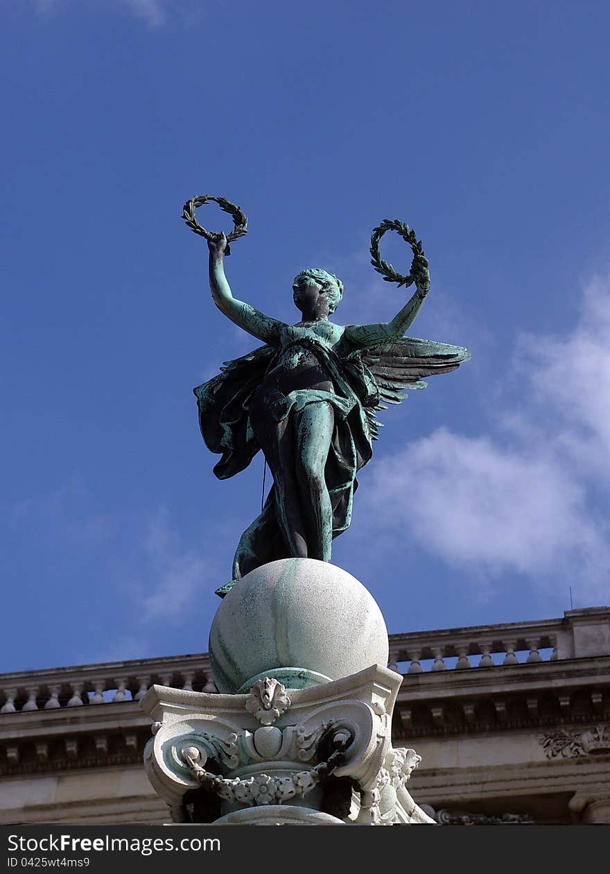 Bronze statue of a winged victory brandishing laurel wreathes. Bronze statue of a winged victory brandishing laurel wreathes