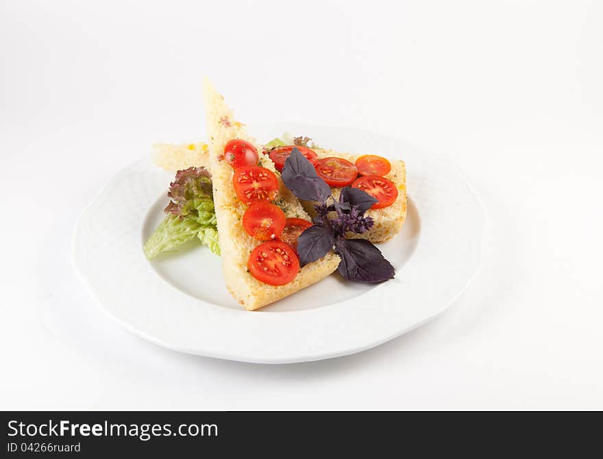 Traditional italian bread bruchetta on a plate with tomatoes