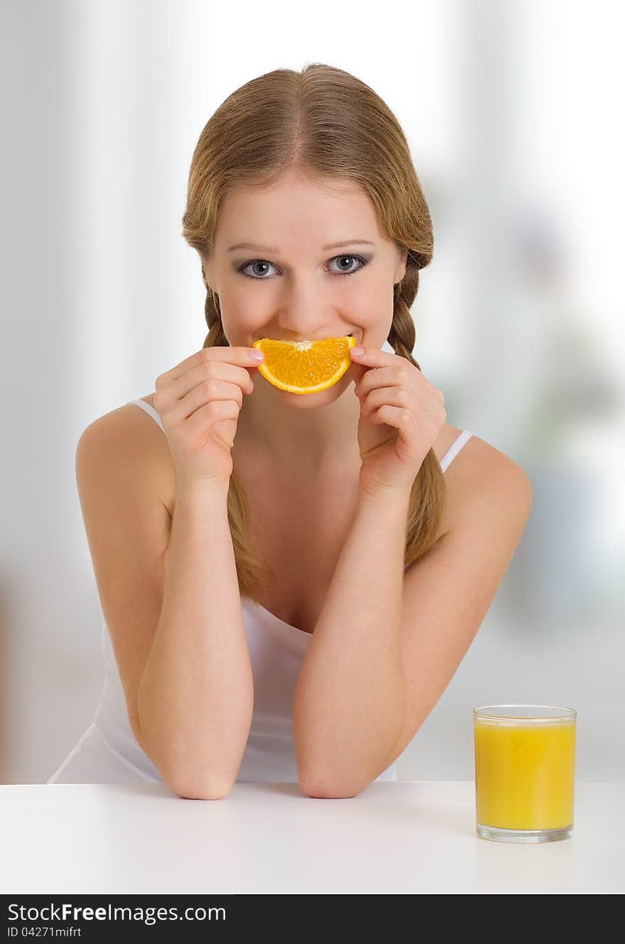 Beautiful girl full of life with orange juice