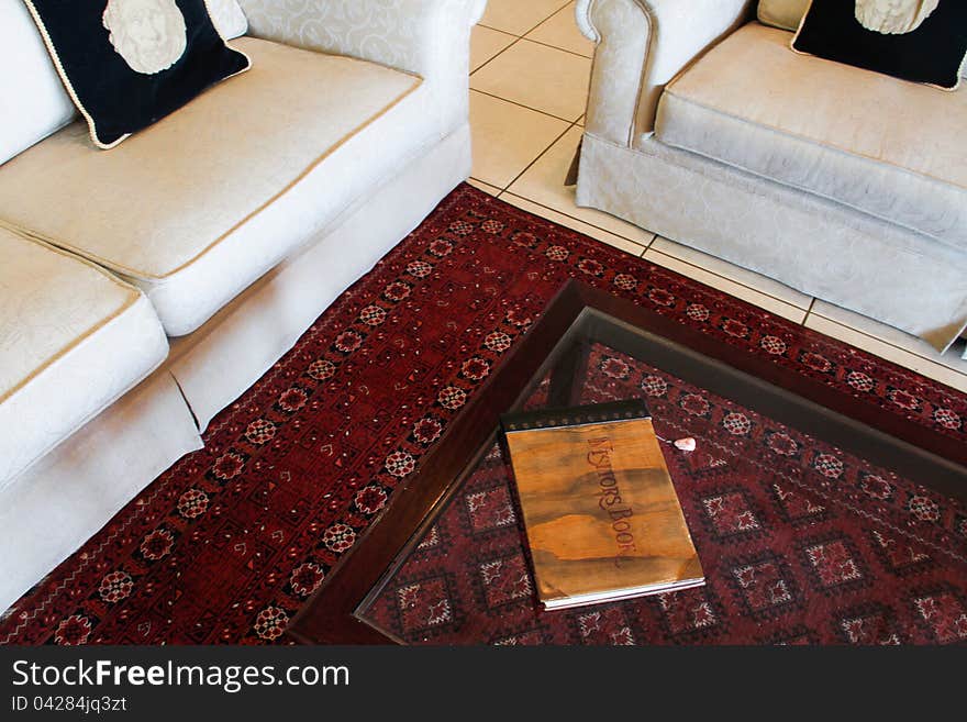 White couches with book on coffee table