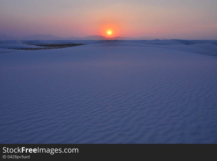 This was taken during the wildfires of 2011, and it is the smoke which causes the haze and the halo around the setting sun. This was taken during the wildfires of 2011, and it is the smoke which causes the haze and the halo around the setting sun.