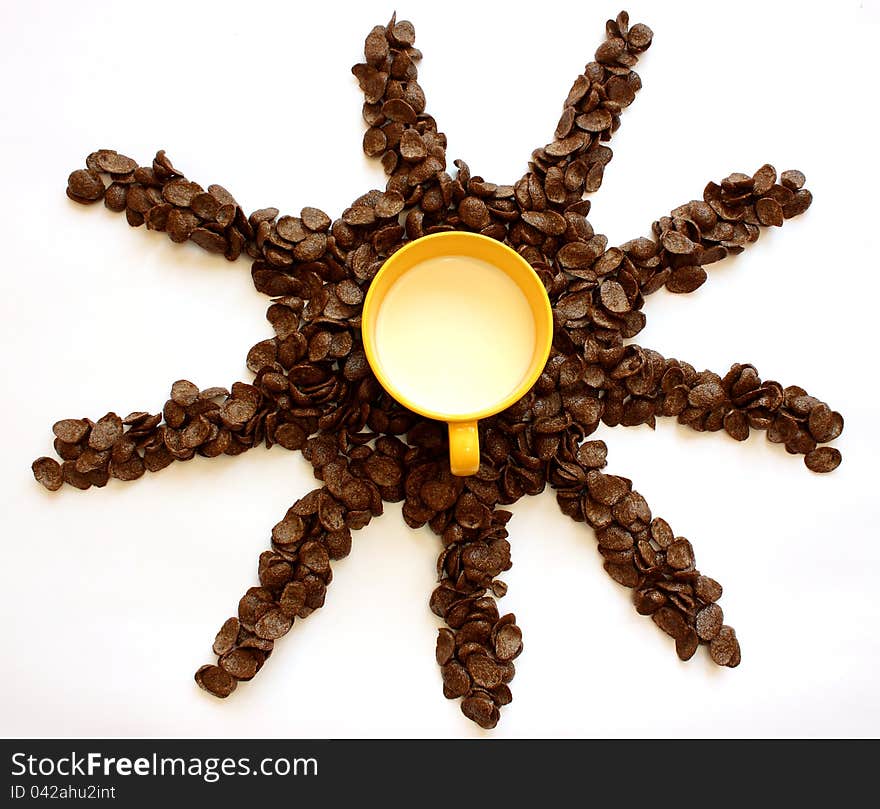 Chocolate cornflakes and bowl with milk on a white background. Chocolate cornflakes and bowl with milk on a white background