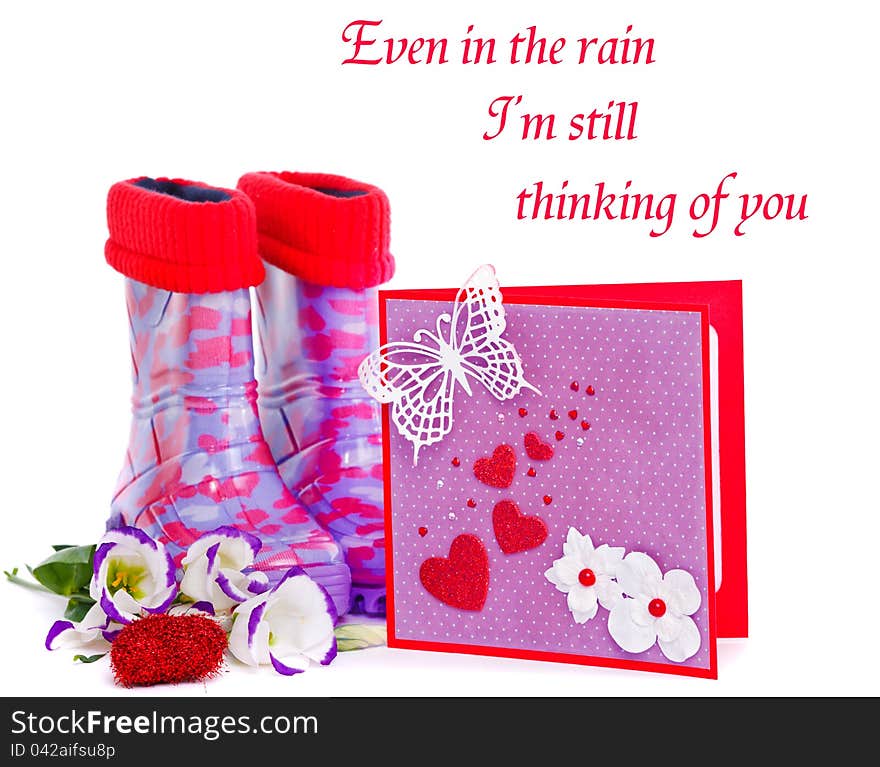 Rubber boots and a valentine greeting card. Rubber boots and a valentine greeting card