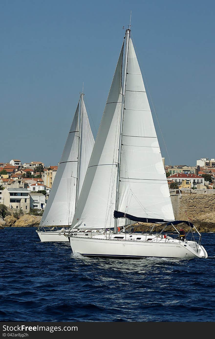 Sailboats attending a regatta alongside the french coast. Sailboats attending a regatta alongside the french coast.