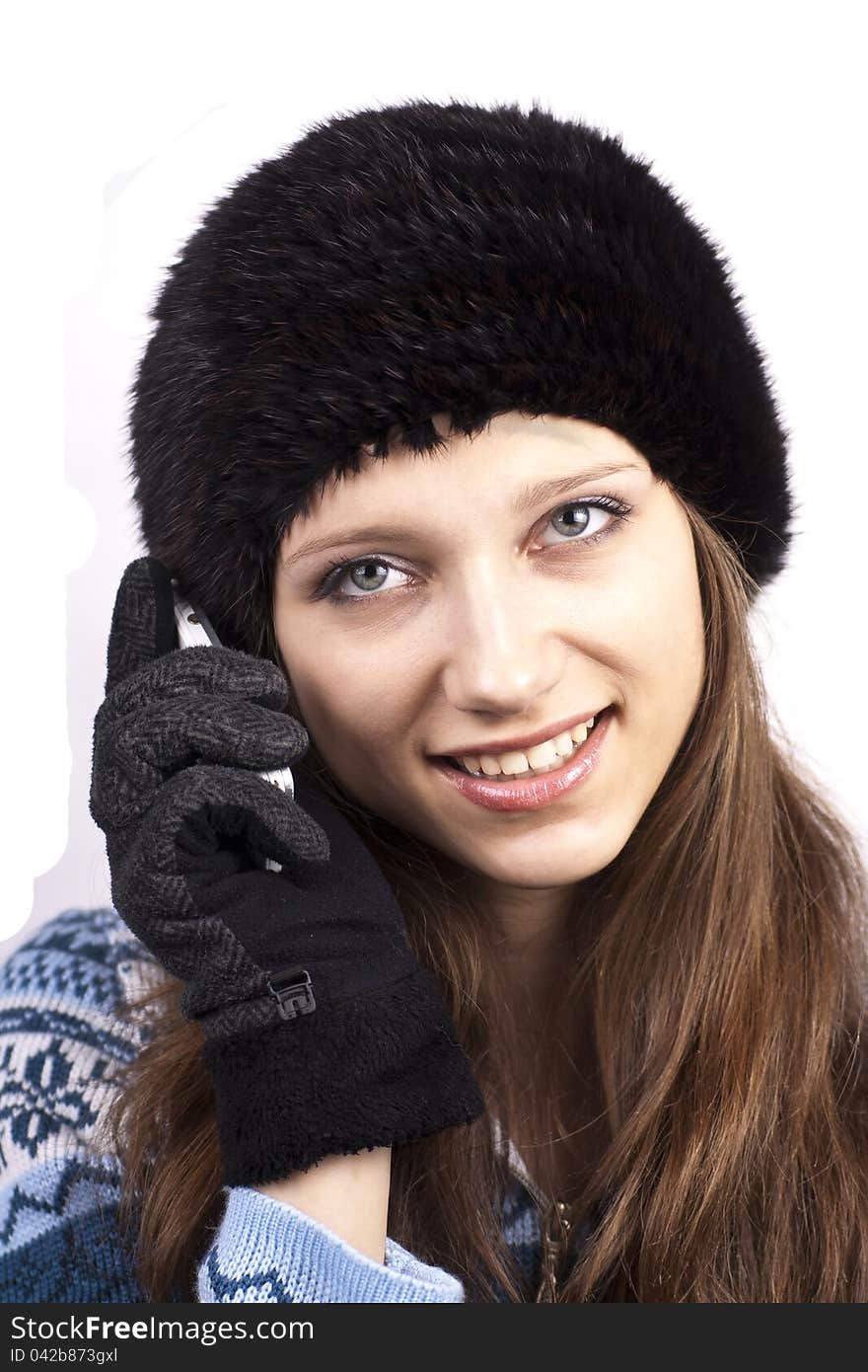 Beautiful woman talking on mobile phone on a white background. Beautiful woman talking on mobile phone on a white background