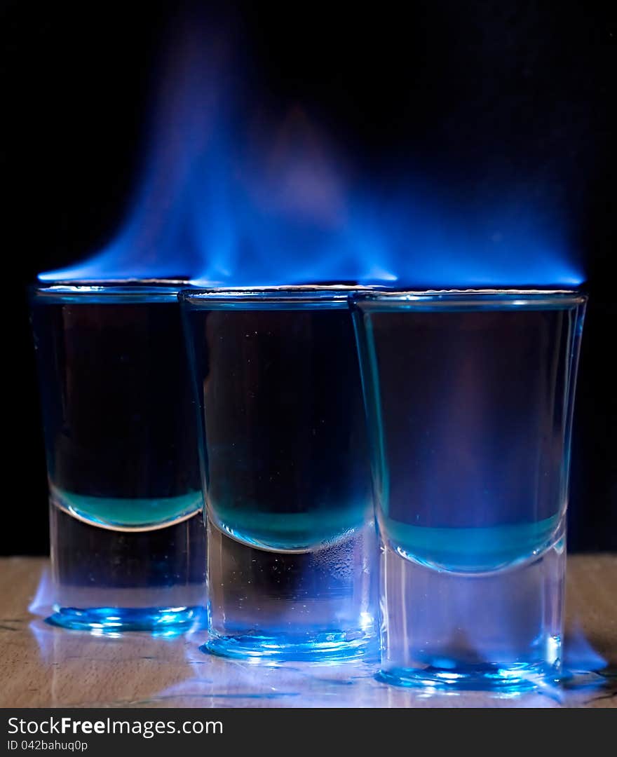 Burning drink in shot glass on a table