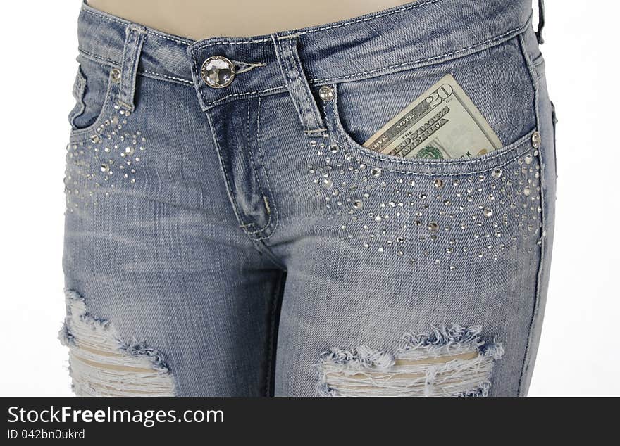 Closeup of woman\'s jeans front pocket with money inside on a white background