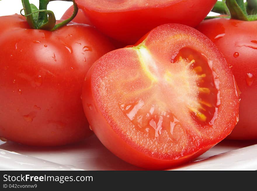 Wet tomatoes closeup on plate