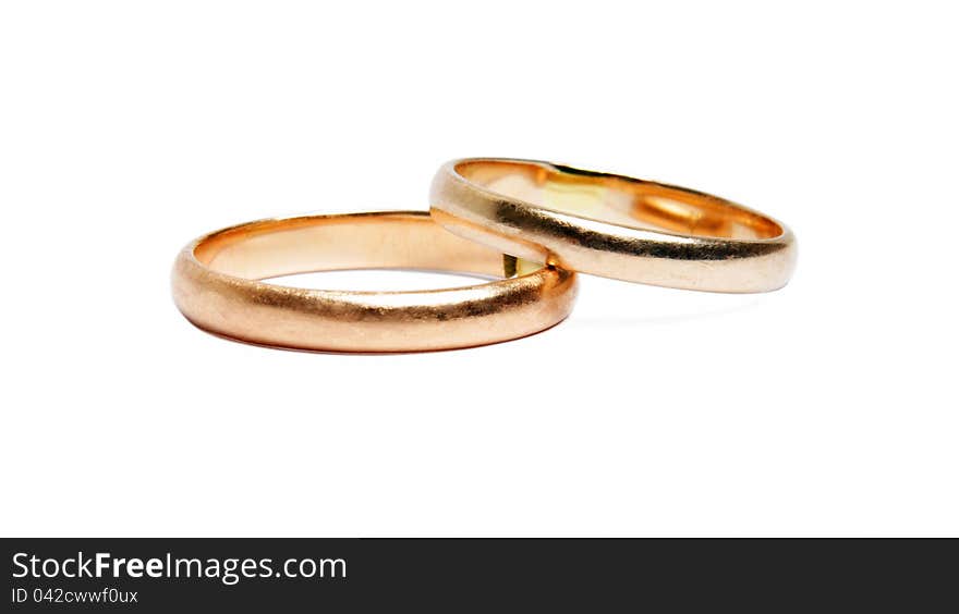 Two worn golden rings on white. Two worn golden rings on white