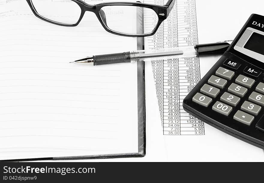 Calculator and pen on a business background