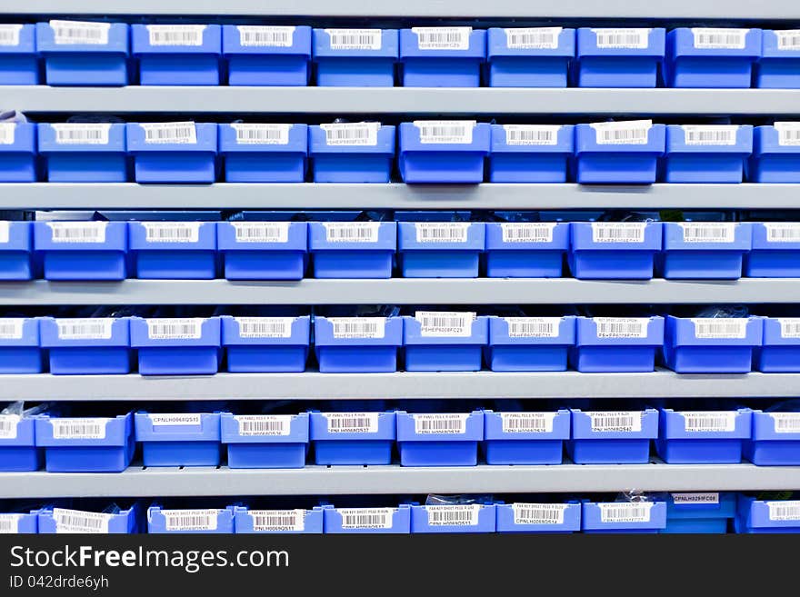 Blue plastic boxes in storage stand