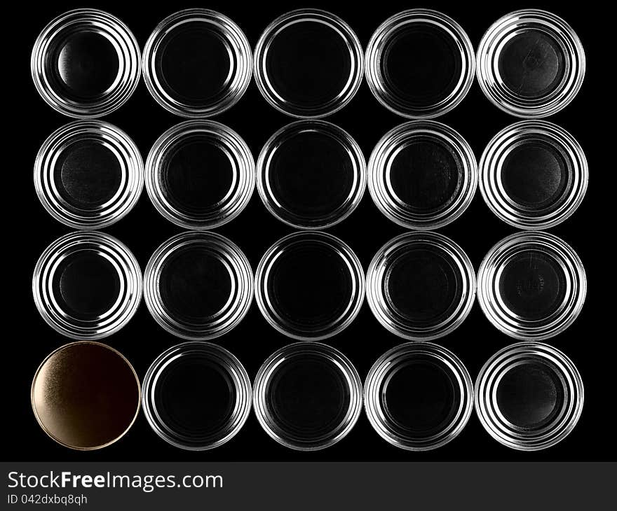 Bottoms of cans on a black background.