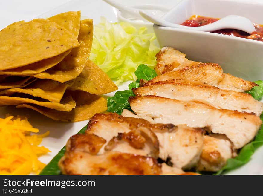 Chicken nacho and salsa sauce on white plate. Chicken nacho and salsa sauce on white plate