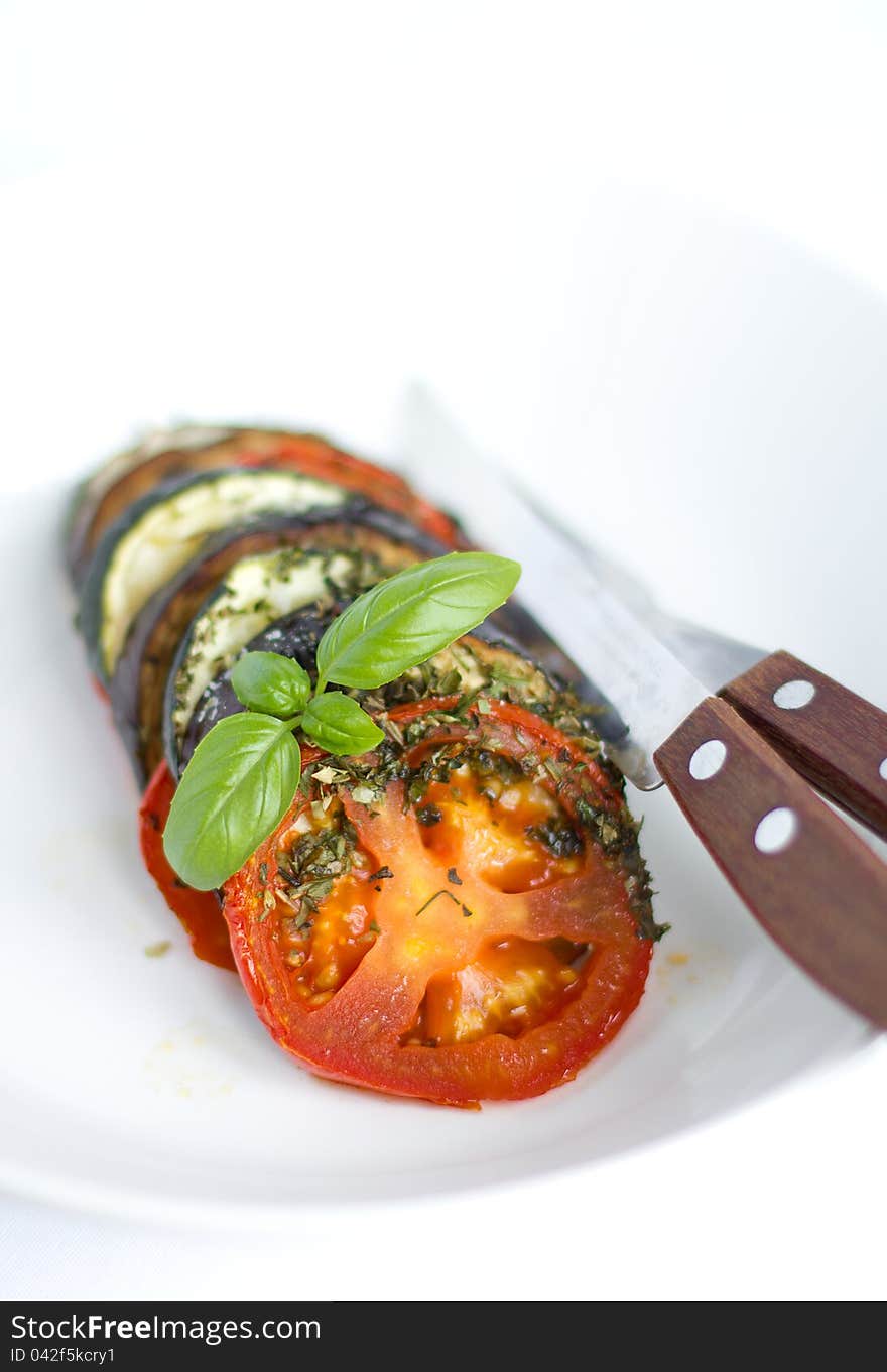 Plate of delicious ratatouille dish with herbs and basil leavef