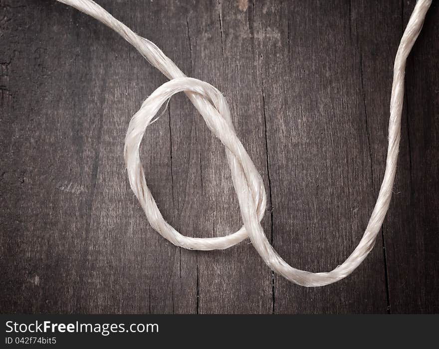 Close up of rope on wooden plank. Close up of rope on wooden plank