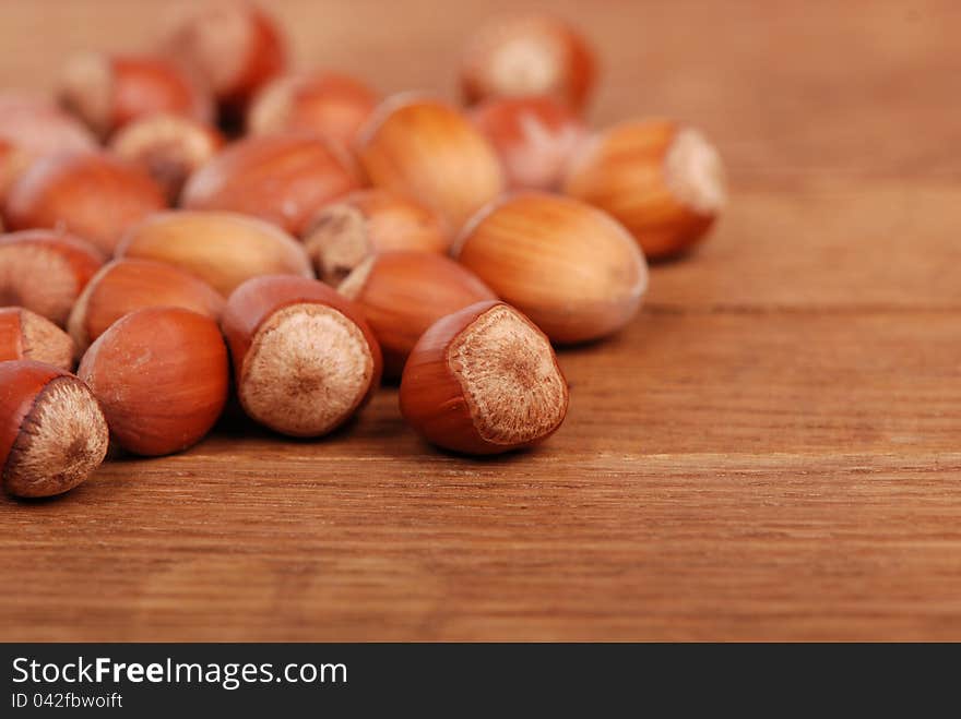 Photo of some filbert nuts over wooden background. Photo of some filbert nuts over wooden background