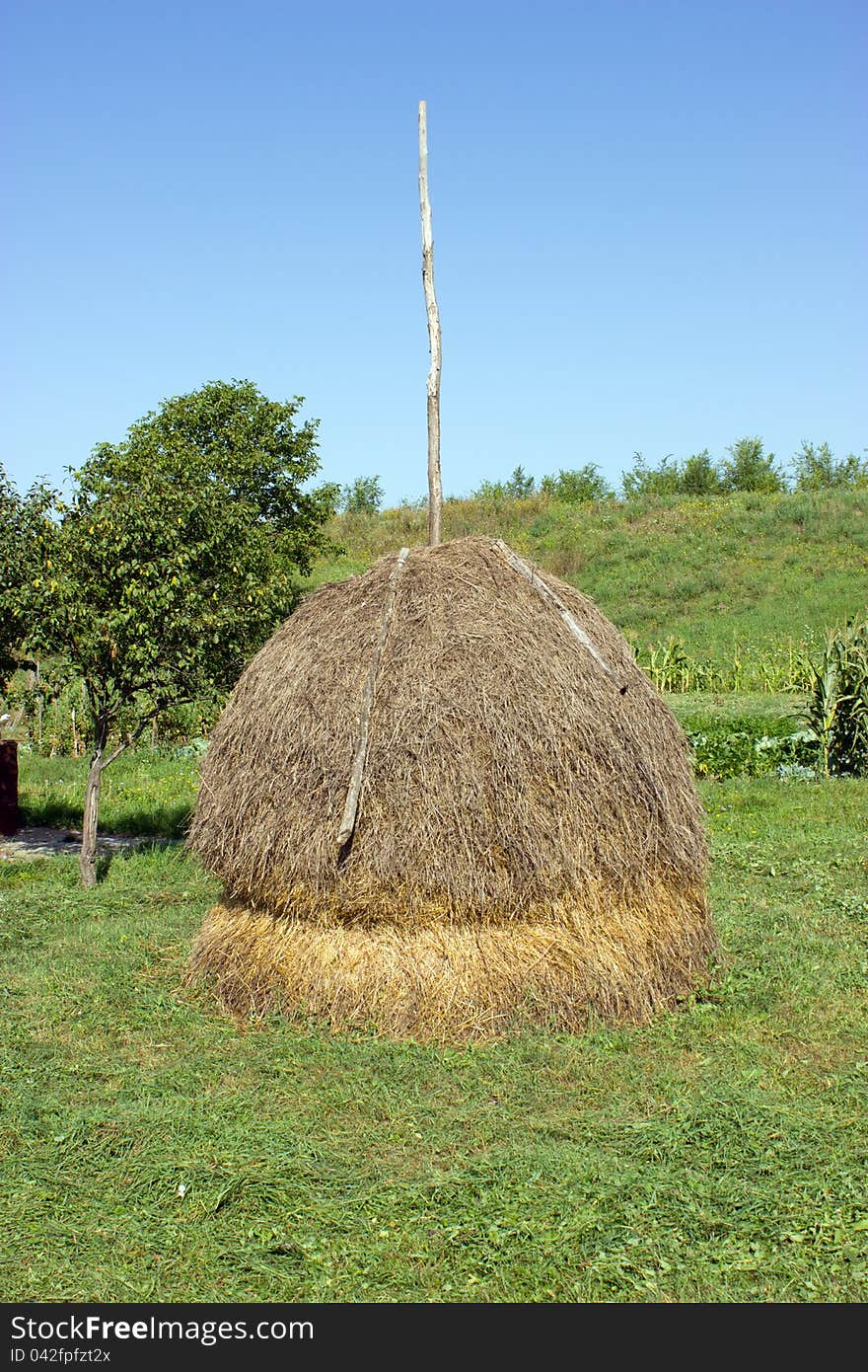 Haystack near the garden with vegetables