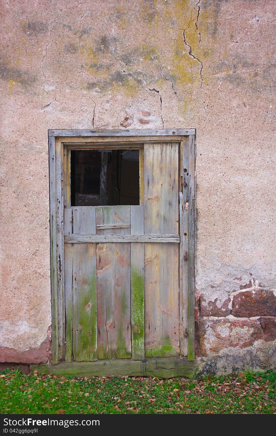 An old weathered gray wooden barn door